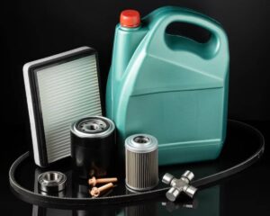 A collection of automotive parts including oil, filters, bearings, and a timing belt against a dark background.